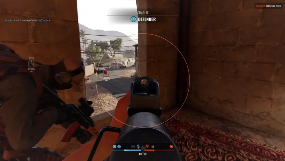 First-person shooter game view showing a player aiming at a target through a scope. Another armed character crouches nearby. Rugged textures and tension evident.