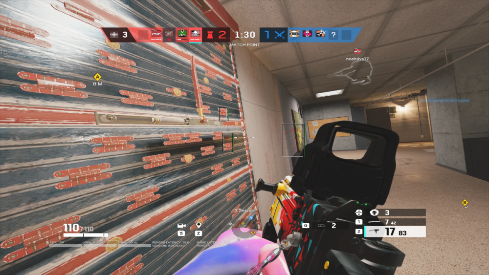 A first-person view in a video game depicts a player aiming a weapon at a reinforced, wooden barricade in a hallway. Game HUD details are visible.