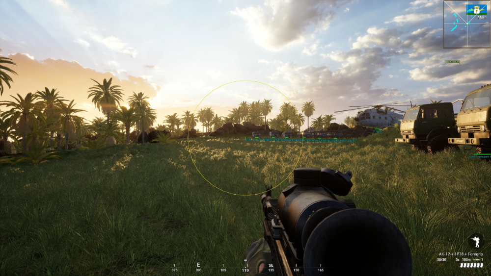 A first-person view in a video game shows a grassy field at sunset, dotted with palm trees. A helicopter and trucks are in the background. The scene feels tense yet calm.