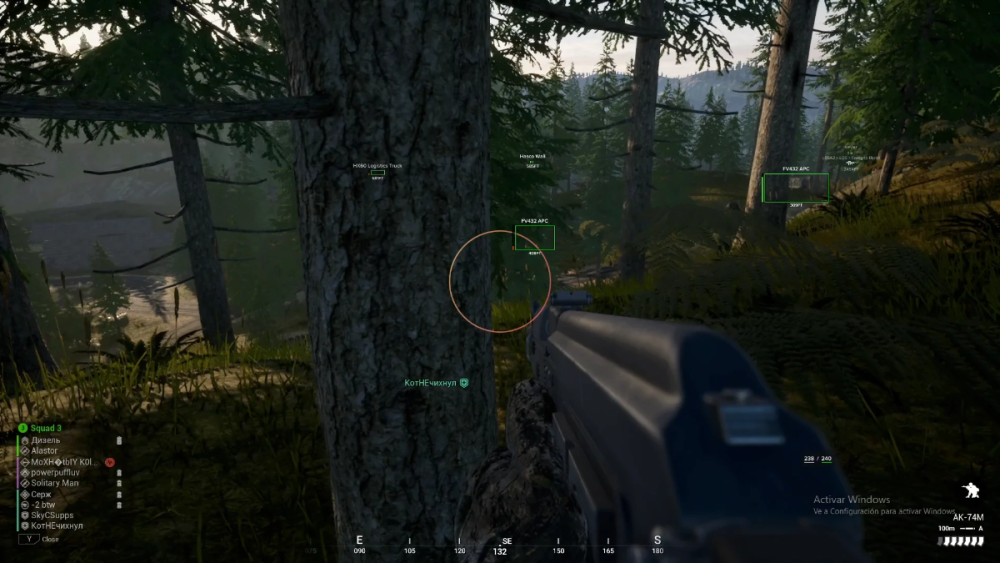 First-person view in a forest setting in a video game. The player is aiming a weapon with a tree in the foreground. Various game elements like team member names and a compass are displayed on-screen, suggesting a tactical, intense atmosphere.