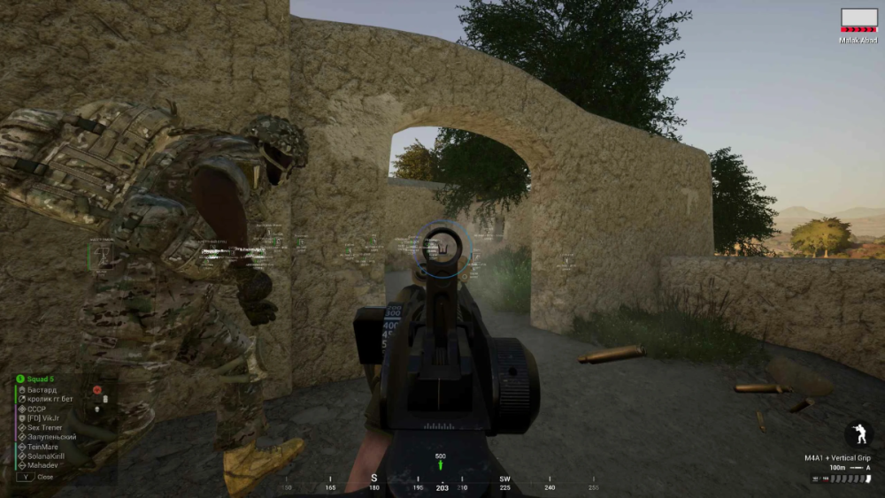First-person shooter video game scene, showing a soldier in camo gear running through a stone archway. The player aims a rifle with serene landscape beyond.