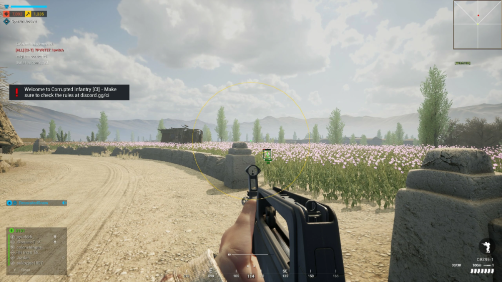 First-person view of a video game with a rifle pointed toward a field of flowers. The scene is in bright daylight with mountains in the background. On-screen text and HUD elements indicate game information and a welcome message.