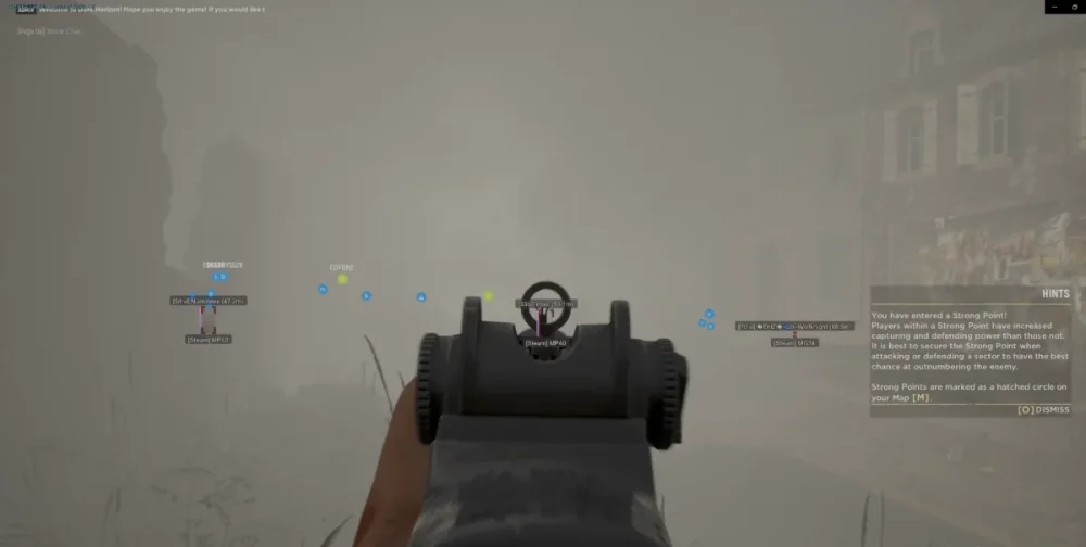 First-person shooter game scene with a gun aimed at a foggy street. Blue and green markers indicate player positions. The mood is tense and immersive.