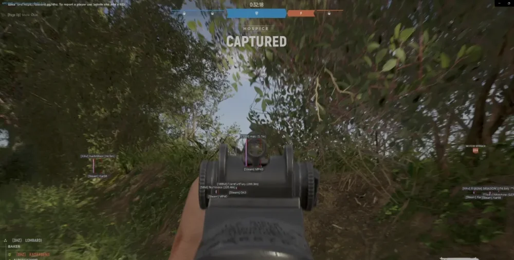 First-person view of a video game, aiming a rifle sight at a bushy landscape. The word 'Captured' is displayed, indicating a game event.