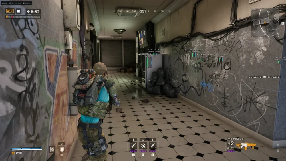 A person in tactical gear navigates a graffiti-marked hallway with tiled flooring in a video game setting. The mood is tense and action-oriented.