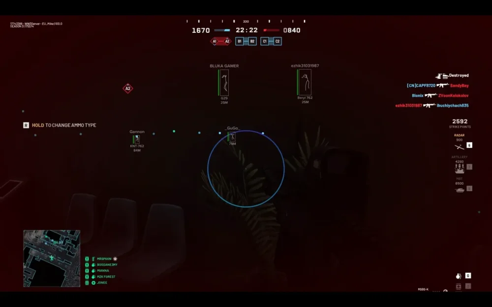 Screenshot of a first-person shooter video game interface. The player is hiding behind a plant, with a blue target reticle centered onscreen. Game stats are in the upper corners, with a map in the bottom left. The atmosphere is tense and strategic.
