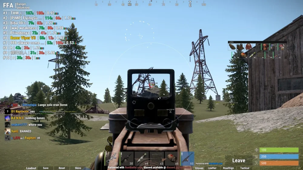 First-person shooter game interface showing a gun aimed at power lines against a forest backdrop. On-screen stats and chat visible. Action-focused atmosphere.