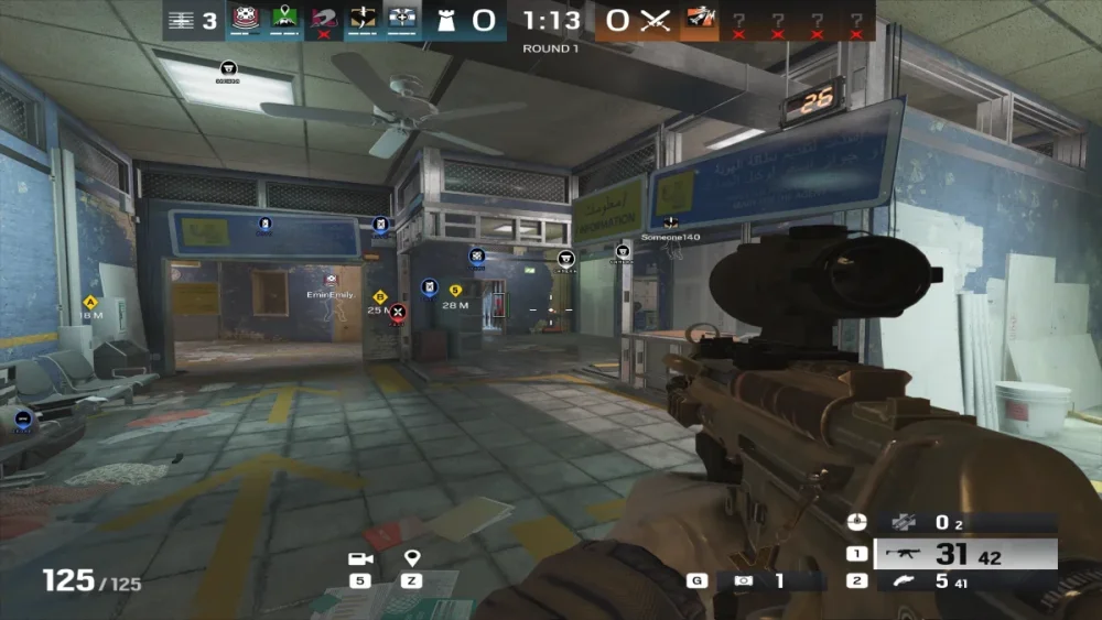 A first-person shooter game scene set in a dimly lit, abandoned office space. The player aims a scoped rifle, while blue and yellow markers highlight objectives.